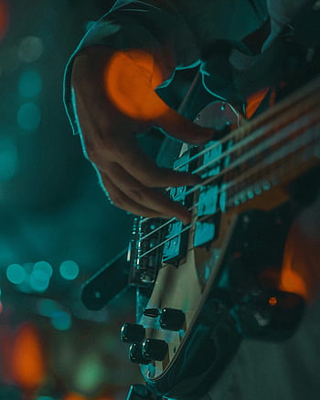bass guitar, bassist, live music performance, Rome Italy, strumming, musical instrument, stage lighting, concert, musician, electric bass, performance