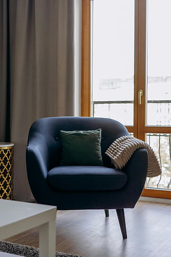 blue armchair, cushion, glass door, stylish interior, elegant armchair, living room, modern furniture, cozy decor, indoor setting, home decor, comfortable seating