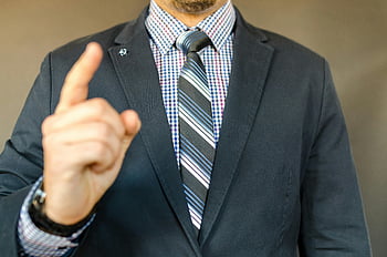 man in suit, close-up, gesture, instruction, guidance, formal attire, business suit, pointing, professional, male, tie