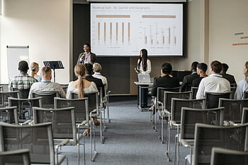 business seminar, audience listening, presenters sharing, data insights, professional event, conference room, revenue split, quarter and geography, business presentation, corporate training, seminar attendees