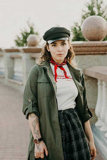 woman, black hat, neck scarf, posing, stylish outfit, modern casual fashion, outdoor fashion, trendy clothing, plaid skirt, olive jacket, red bandana