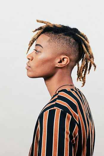 profile view, person, striped shirt, young person, loc hairstyle, white background, profile portrait, distinctive locs, side view, casual style, studio shot