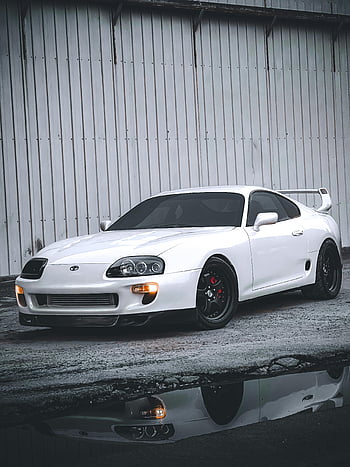 white Toyota car, white sports car, parked on pavement, industrial warehouse, white car, sports car, Toyota, pavement, warehouse, car reflection, white exterior