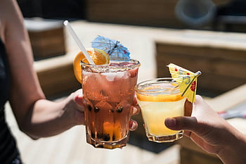 summer cocktails, refreshing drinks, citrus cocktails, outdoor drinks, cocktail umbrellas, summer day, drinking glasses, two people, outdoor refreshments, summer beverages, citrus garnish