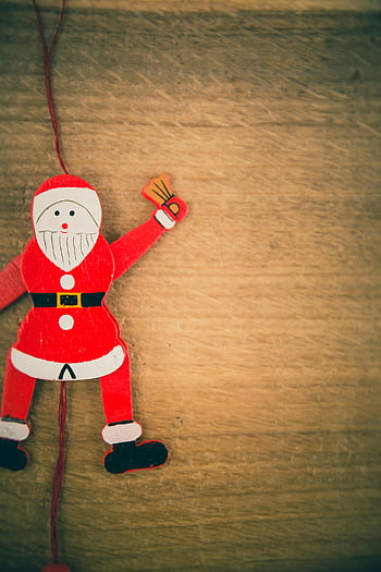 Santa Claus ornament, wooden Santa, holiday decor, wooden surface, Christmas decoration, festive ornament, red and white, wooden toy, holiday ornament, Christmas toy, wooden Santa Claus
