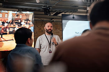 speaker presenting, London event, audience engagement, informative session, public speaking, event speaker, London presentation, audience interaction, professional speaker, event photography, conference speaker