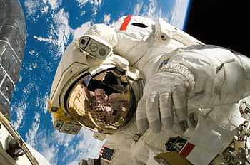 American astronaut, spacewalk, floating in space, Earth in background, astronaut suit, space exploration, outer space, NASA, space mission, international space station, space photography