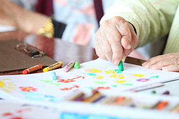 senior adult, drawing, crayons, creative therapy, nursing home, elderly, art activity, colorful, hand, paper, table