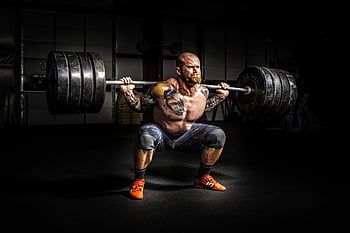 man lifting barbell, weightlifting, gym workout, fitness, strength training, barbell squat, muscular man, tattoos, orange shoes, dark gym, intense exercise