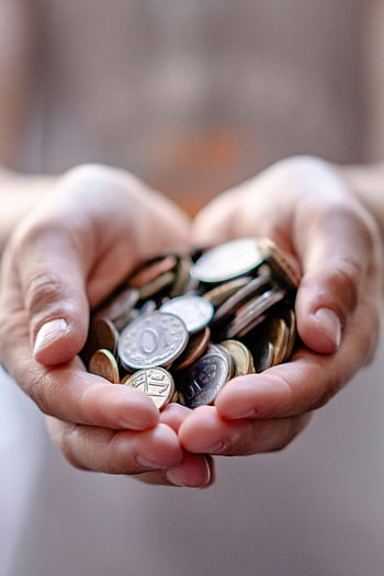 hands cupping coins, saved coins, wealth representation, savings concept, assorted coins, close-up hands, financial savings, coin collection, money saving, personal finance, coin pile