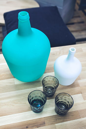 bottle, glasses, stylish still life, glass bottles, cups, wooden table, modern decor, themes, turquoise bottle, white bottle, black glasses