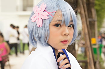 cosplay, blue hair, floral accessory, shallow focus, close-up portrait, young woman, outdoors, anime character, cosplay photography, cosplay outfit, cosplay event