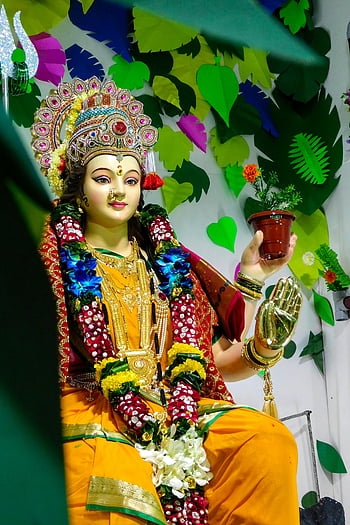 Hindu Goddess Durga, statue, vibrant depiction, festive setting, floral decorations, colorful background, traditional attire, ornate jewelry, cultural art, religious icon, divine figure