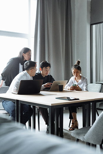 office meeting, young professionals, contemporary office, teamwork, group discussion, working together, office setting, business people, collaborative work, modern office, professional meeting