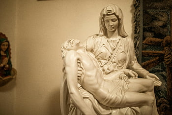 Pieta sculpture, religious art, indoor display, intricate craftsmanship, close-up shot, detailed view, religious Pieta, indoor sculpture, craftsmanship details, religious statue, indoor art