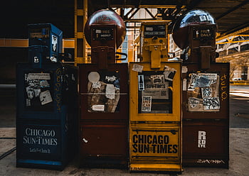 vintage newspaper vending machines, urban Chicago, daytime shot, Chicago Sun-Times, newspaper dispensers, retro vending machines, cityscape background, street scene, public space, urban environment, daily newspapers