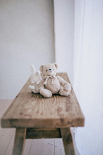 teddy toys, teddy bear, rabbit plush, rustic wooden table, cozy atmosphere, stuffed animals, plush toys, wooden surface, teddy and rabbit, soft toys, home decor
