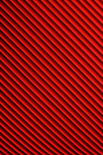 red textile, vibrant red, diagonal pattern, abstract background, red and black, close-up photo, textile design, abstract design, red stripes, patterned textile, vibrant texture
