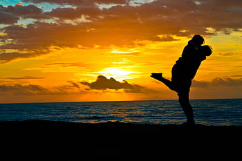 sunset silhouette, romantic couple, beach sunset, love and tranquility, seashore couple, romantic embrace, sunset beach, couple silhouette, romantic scene, beach couple, sunset couple
