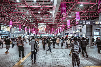 subway station, commuters, vibrant signage, urban life, indoor train station, bustling crowd, city commuters, public transportation, busy station, travel hub, urban commuters