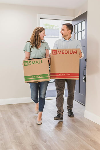 moving couple, new home, carrying boxes, happy couple, indoor moving, cardboard boxes, moving journey, small box, medium box, moving day, home relocation