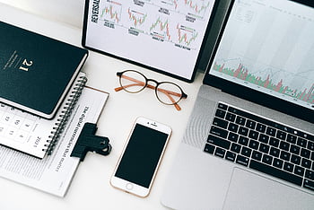 laptop, eyeglasses, smartphone, organized workspace, financial data, graphs, notebook, calendar, digital currencies, office desk, technology