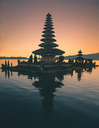 Balinese pagoda, lake reflection, twilight scene, spirituality, peace, tranquil water, temple architecture, cultural landmark, serene landscape, travel destination, Indonesia travel