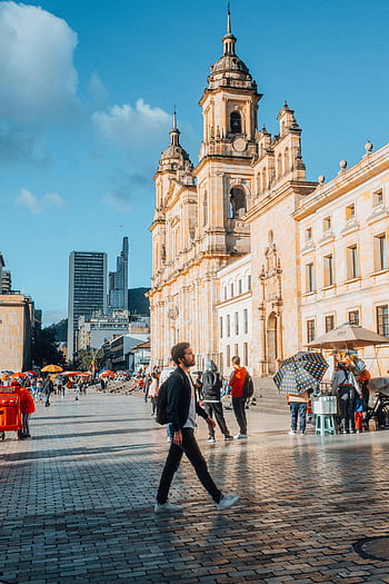 Plaza de Bolivar, Bogota, Bolivar Square, historic cathedral, lively urban atmosphere, Colombia, cityscape, tourists, street vendors, architecture, blue sky
