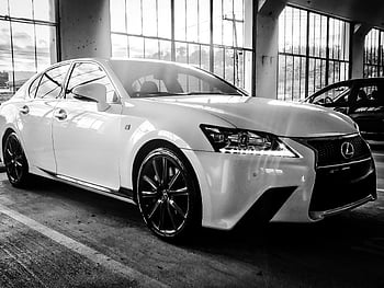 grayscale photography, Lexus sedan, black and white, indoor setting, luxury design, stylish car, high-end vehicle, monochrome image, automotive photography, car showcase, luxury sedan