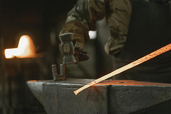 blacksmith, workshop, hammer, hot iron, anvil, dimly lit, shaping metal, traditional craft, forge, artisan, craftsmanship