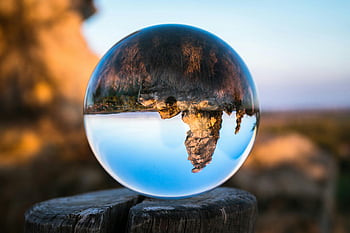 clear glass ball, crystal ball, inverted landscape, wooden stump, daylight, outdoor decor, nature reflection, spherical lens, landscape photography, glass sphere, crystal decor