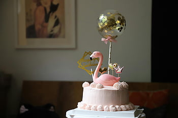 pink flamingo, cake decoration, elegant birthday cake, indoor celebration, balloon decoration, pink cake, flamingo topper, birthday party, festive cake, cake design, indoor cake display