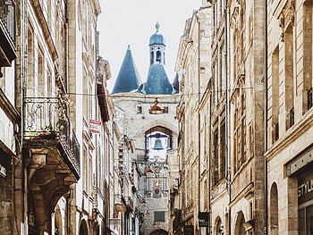 Brown Building, charming city street, iconic bell tower, classic architecture, cityscape, urban view, historic building, European architecture, narrow street, old town, bell tower view