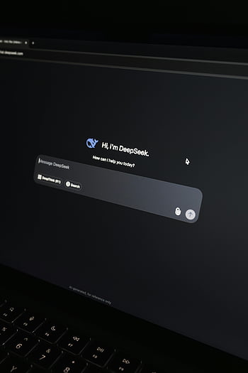 AI chat interface, laptop screen, dark setting, close-up, DeepSeek, chatbot, digital conversation, technology, user interface, computer, communication
