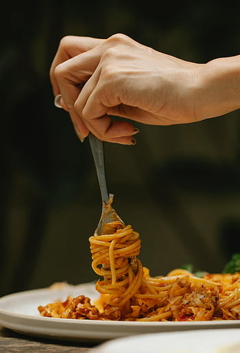 spaghetti bolognese, rolling spaghetti, fork, Italian cuisine, close-up shot, dinner, restaurant, twirling spaghetti, delicious food, pasta dish, hand holding fork