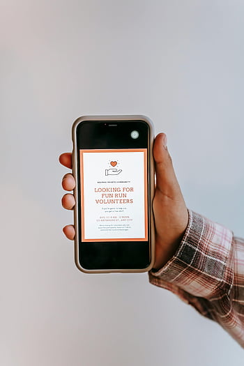 smartphone, volunteer recruitment, fun run event, hand holding phone, event advertisement, community event, volunteer ad, fun run volunteers, event poster, plaid shirt, white background