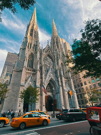 St. Patrick's Cathedral, Gothic Revival architecture, NYC, low angle shot, iconic cathedral, New York City, urban landscape, historic building, religious landmark, cityscape, yellow taxis