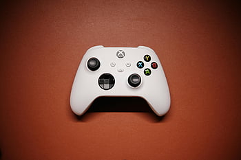 Xbox controller, red background, white Xbox, isolated controller, gaming controller, video game controller, red backdrop, controller shadows, Xbox gaming, gaming accessories, red surface