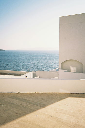 minimalist architecture, coastal architecture, modern white architecture, ocean view, serene ocean, travel photography, architecture themes, beachfront buildings, minimalist design