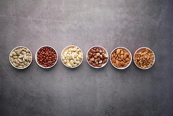 nuts, bowls, close-up, flat lay, assorted nuts, textured gray surface, healthy food options, peanuts, almonds, cashews, walnuts