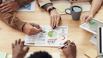 office meeting, colleagues discussing, data analysis, strategy discussion, graphs and rates, business meeting, team collaboration, office environment, data visualization, professional discussion, office workspace