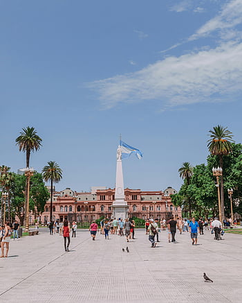 Plaza de Mayo, Casa Rosada, Argentine flag, Buenos Aires, people walking, park, iconic landmark, Argentina, public square, tourists, monument