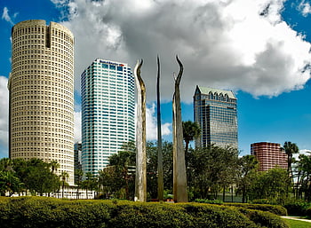 Tampa skyline, high-rise buildings, tall skyscrapers, modern sculptures, bright sky, urban landscape, cityscape, downtown Tampa, architectural landmarks, outdoor art, Florida architecture