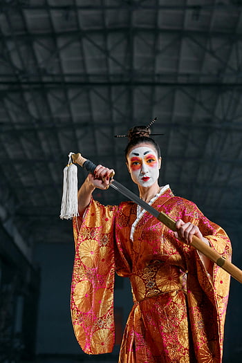 woman in kimono, holding sword, geisha, colorful kimono, katana, artistic setting, striking portrait, traditional Japanese attire, cultural fusion, warrior geisha, dramatic pose
