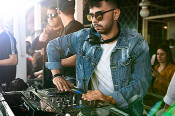 DJ, controller, mixing, music, lively, club, dancing, crowd, stage, performance, headphones