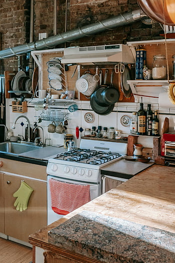 kitchen, kitchenware, appliances, rustic elements, modern appliances, natural light, well-organized kitchen, granite countertop, hanging pots, wooden shelves, brick wall