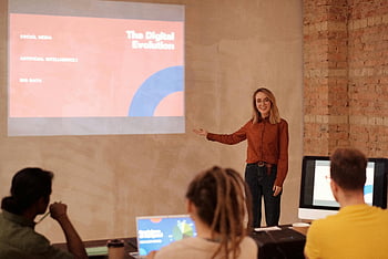 woman in red shirt, digital evolution, AI, big data, seminar presentation, young woman presenting, long sleeve shirt, professional setting, audience engagement, educational seminar, technology concepts