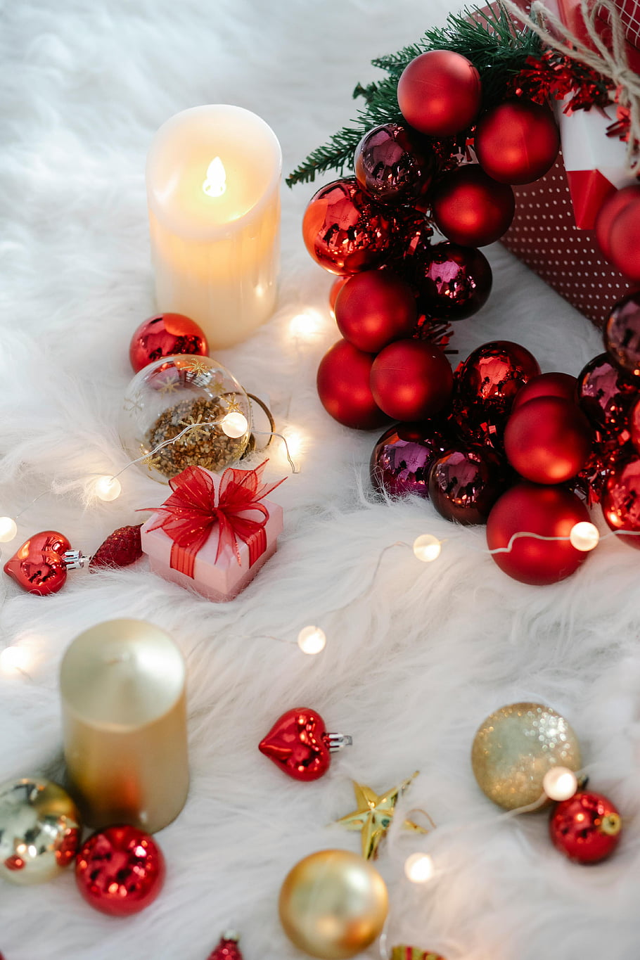 decorazioni natalizie, candela fiammeggiante, palline colorate, vacanze di capodanno, Scena luminosa, ornamenti, corona, luci festive, arredamento per le vacanze, ornamenti rossi, pacco regalo