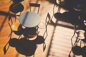 round black table, chairs set, sunlit cafe, empty tables, wooden floor, intricate shadows, cafe interior, table chairs, cafe furniture, cafe decor, cafe seating