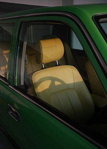 vintage car seat, retro car interior, yellow leather seats, sunlight shadows, Tokyo, car window, green car, classic car, car interior design, vintage car, retro car